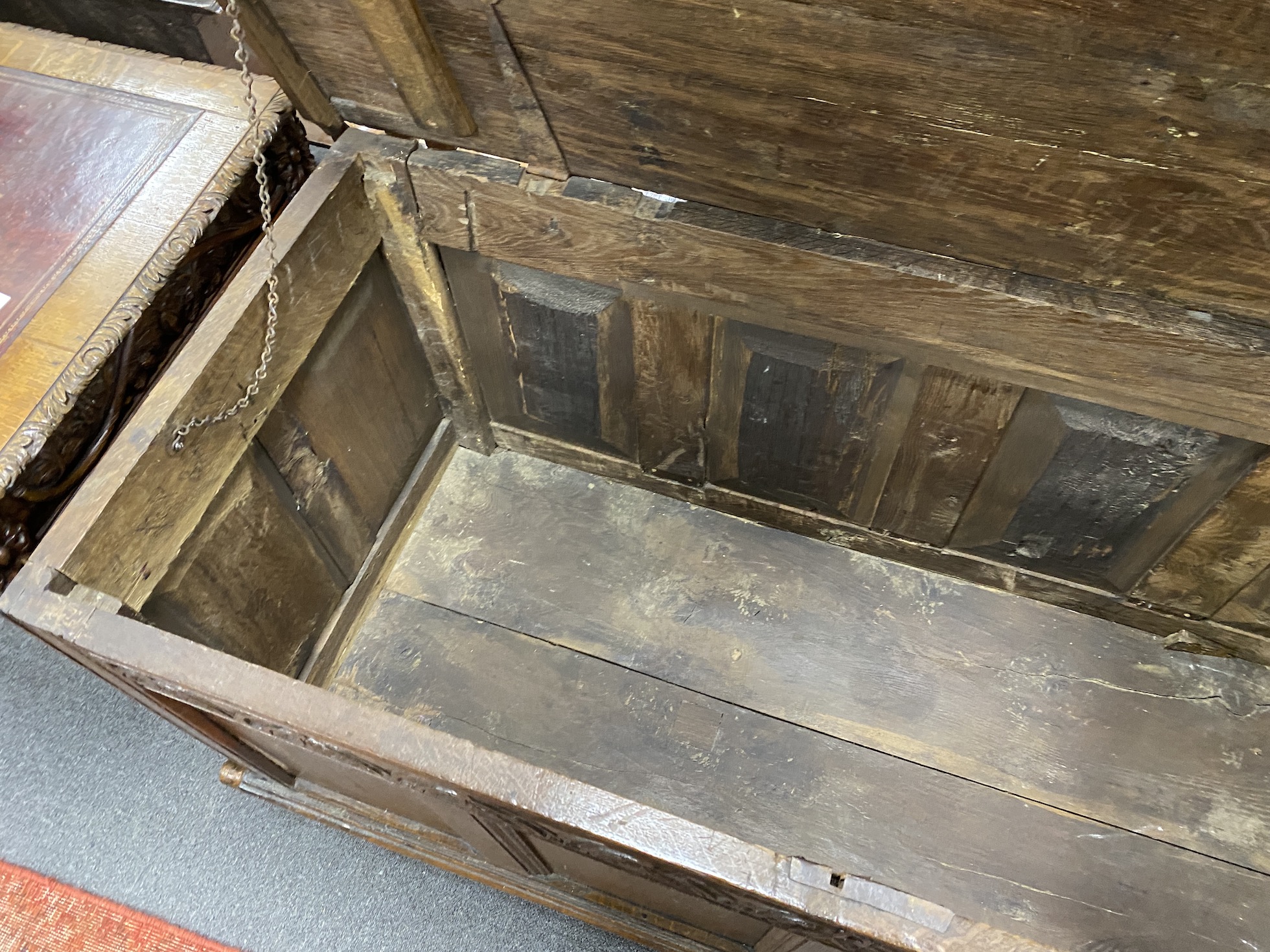 An 18th century panelled oak coffer (sun bleached top), length 147cm, depth 62cm, height 73cm